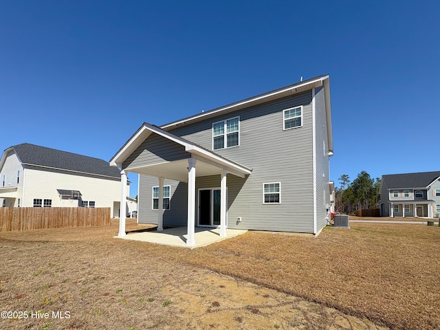 rear view of house featuring a patio area, central AC unit, a yard, and fence