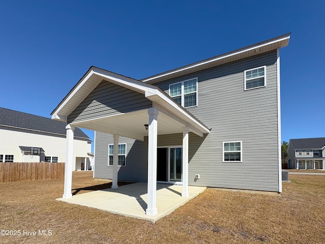 rear view of property with a patio and fence