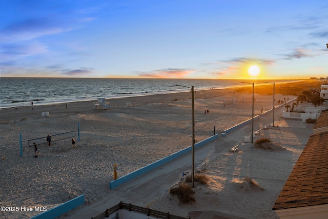 view of home's community featuring a water view and a view of the beach