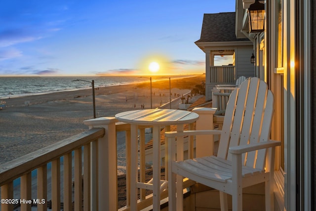 balcony featuring a water view and a beach view