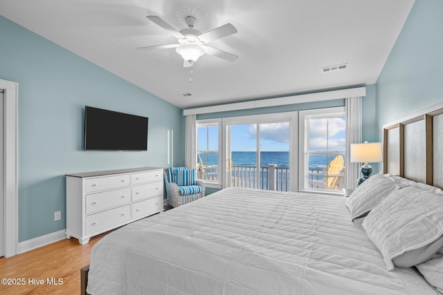 bedroom featuring access to exterior, light wood finished floors, visible vents, vaulted ceiling, and baseboards