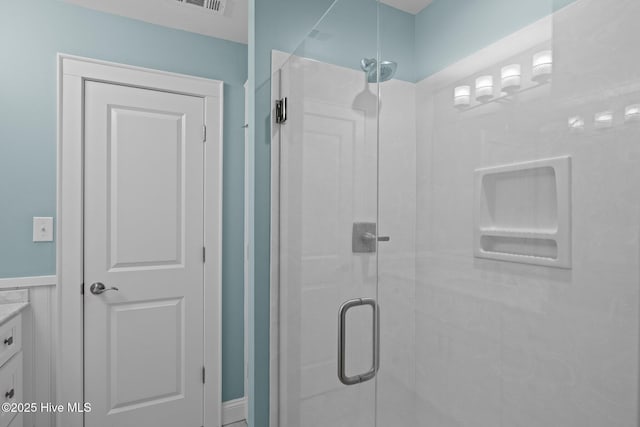 bathroom featuring a shower stall, visible vents, and vanity