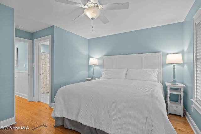 bedroom featuring wood finished floors, a ceiling fan, and baseboards