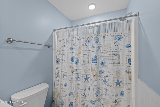 bathroom with toilet and curtained shower