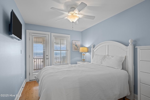 bedroom with access to exterior, ceiling fan, baseboards, and wood finished floors