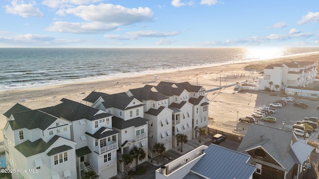 aerial view with a water view and a beach view