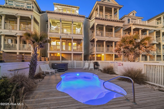 view of swimming pool with area for grilling, fence, and a fenced in pool