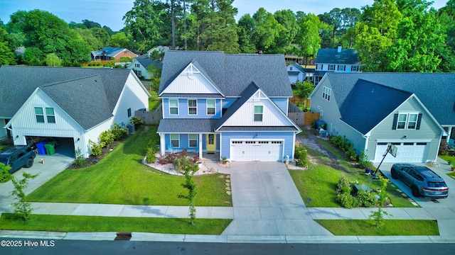 1014 Mccarley Blvd, Wilmington, NC 28412 - view of front of property featuring board and batten siding, driveway, a shingled roof, and a residential view