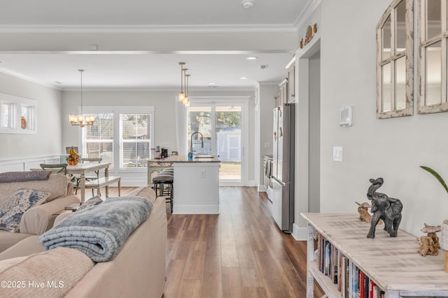 1014 Mccarley Blvd, Wilmington, NC 28412 - living area with dark wood-style floors, recessed lighting, ornamental molding, and a chandelier