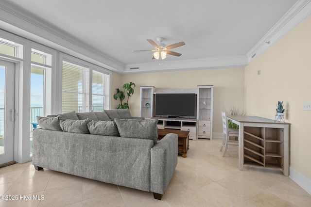 living room featuring baseboards, visible vents, ceiling fan, and crown molding