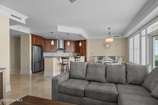 living room with baseboards, light tile patterned floors, visible vents, and crown molding