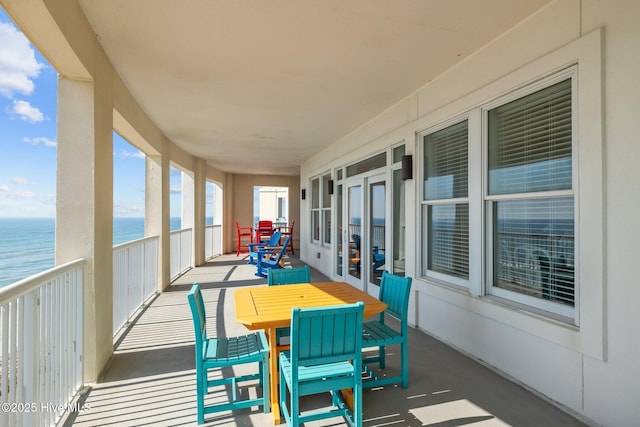 exterior space featuring a view of the beach, french doors, and a water view