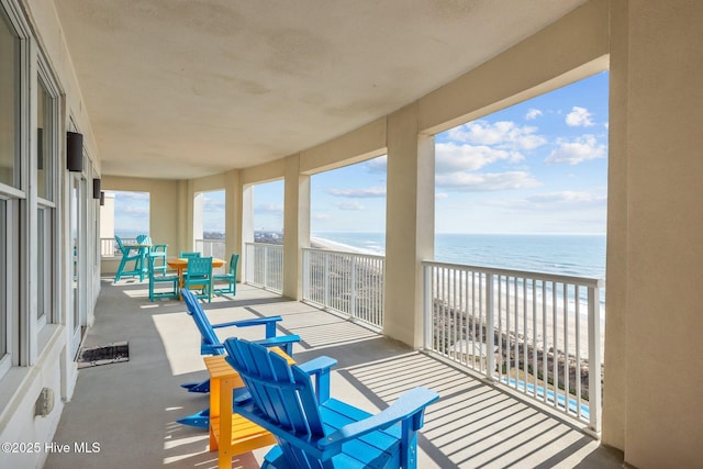 balcony with a beach view and a water view