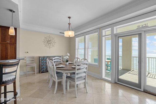 dining space featuring light tile patterned floors, baseboards, and crown molding