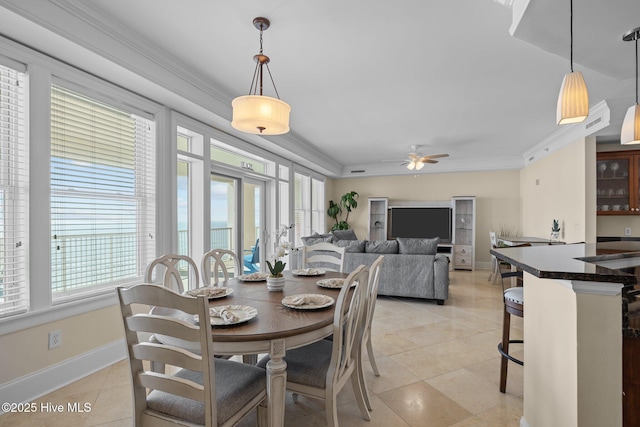 dining area featuring a ceiling fan, baseboards, crown molding, and light tile patterned flooring