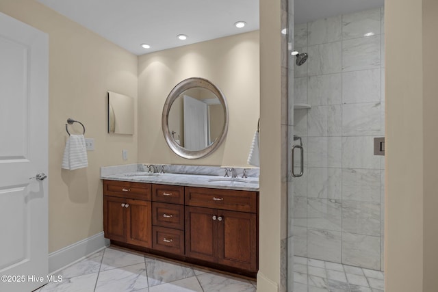 bathroom featuring a sink, baseboards, marble finish floor, double vanity, and a stall shower