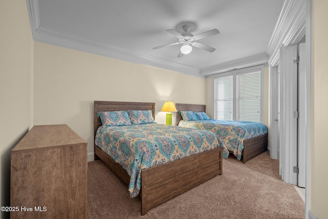 carpeted bedroom with ornamental molding and ceiling fan