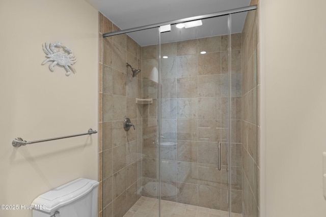 bathroom with a shower stall and toilet