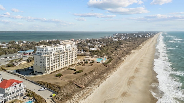 drone / aerial view featuring a water view and a view of the beach