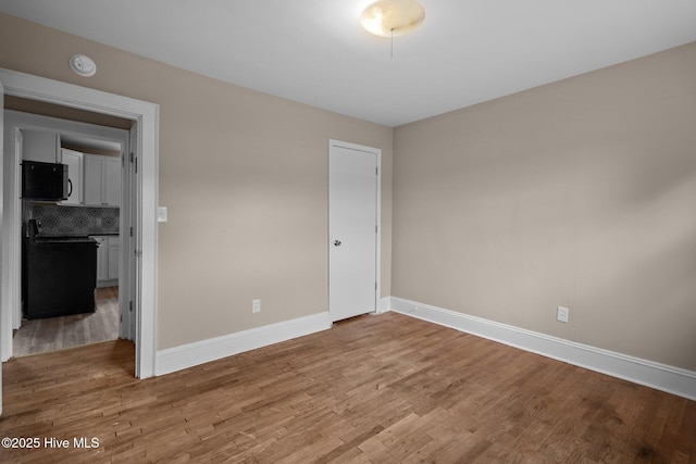 unfurnished bedroom with light wood-style flooring and baseboards