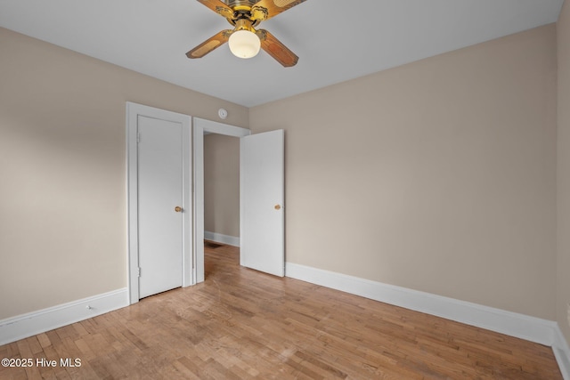 unfurnished bedroom featuring wood finished floors, a ceiling fan, and baseboards