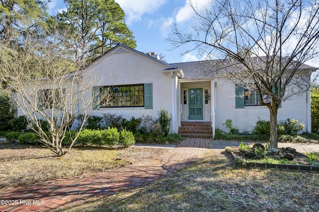 ranch-style house with brick siding and roof with shingles