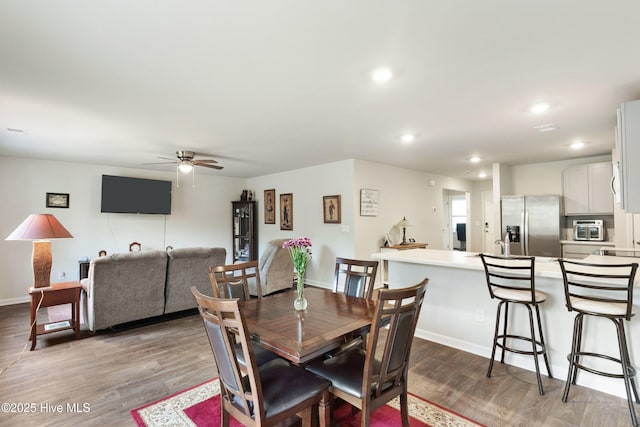 dining room with light wood-style floors, recessed lighting, baseboards, and a ceiling fan