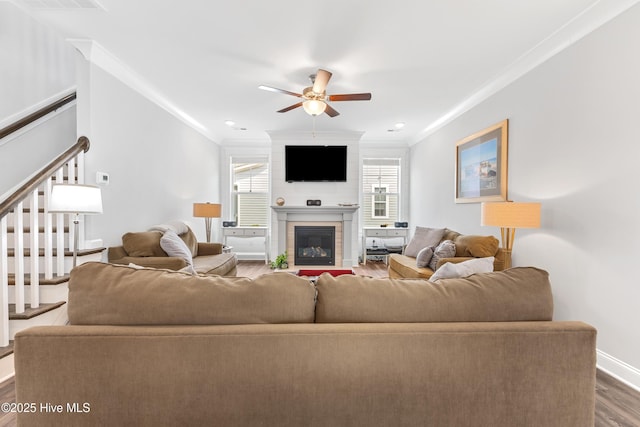 172 Everett Park Trl, Holly Ridge, NC 28445 - living room with crown molding, wood finished floors, a ceiling fan, stairs, and a fireplace