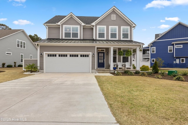 172 Everett Park Trl, Holly Ridge, NC 28445 - view of front facade with a standing seam roof, covered porch, concrete driveway, and a front yard