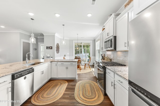 172 Everett Park Trl, Holly Ridge, NC 28445 - kitchen featuring stainless steel appliances, a sink, crown molding, white cabinetry, and light stone counters