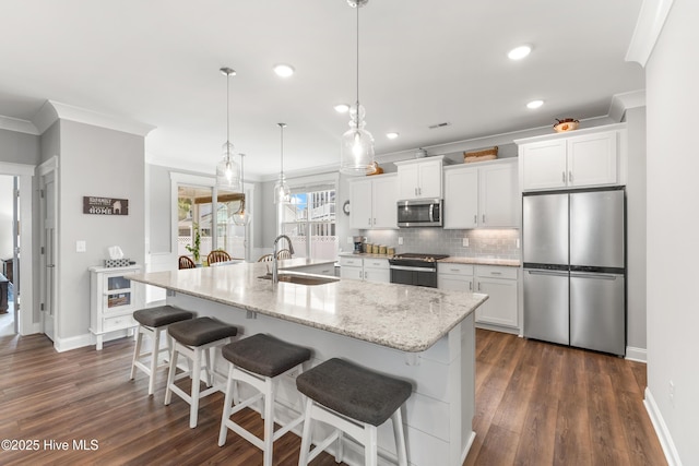 172 Everett Park Trl, Holly Ridge, NC 28445 - kitchen featuring stainless steel appliances, a sink, ornamental molding, backsplash, and white cabinetry