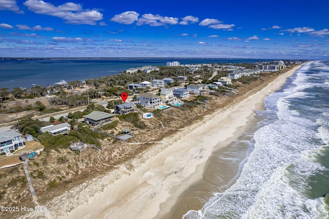 birds eye view of property with a view of the beach and a water view