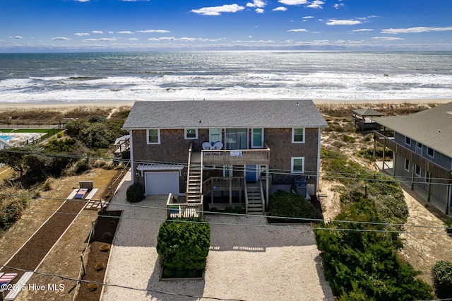 exterior space featuring a water view and a beach view