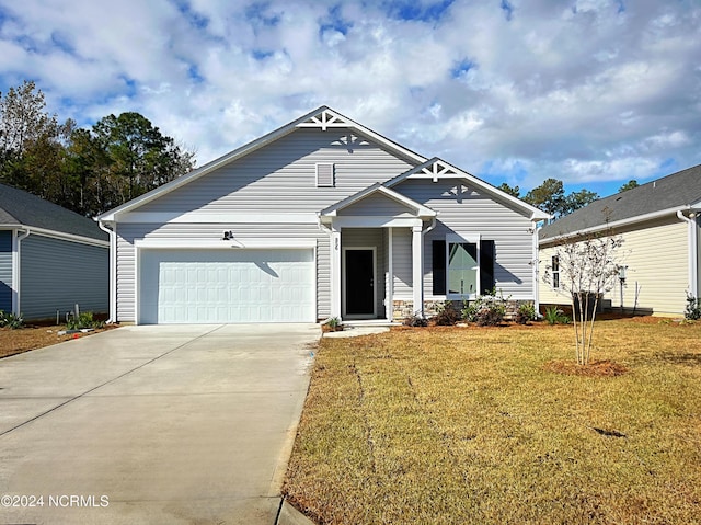 view of front of home featuring a garage, driveway, and a front lawn