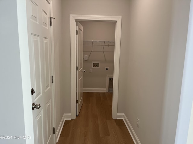 hallway featuring dark wood-style flooring and baseboards