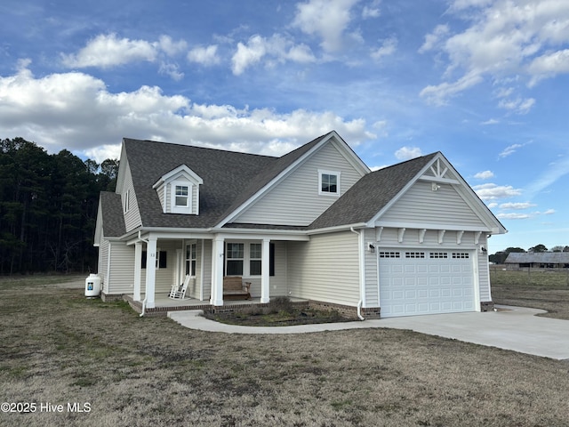 view of front of home with a shingled roof, concrete driveway, a porch, an attached garage, and a front lawn