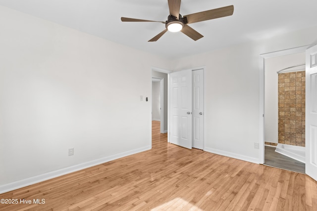 unfurnished bedroom with a closet, ceiling fan, light wood-style flooring, and baseboards