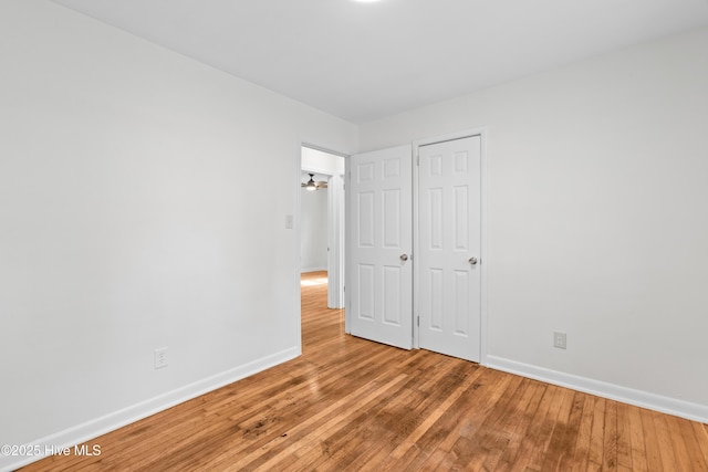 unfurnished bedroom featuring light wood-type flooring and baseboards