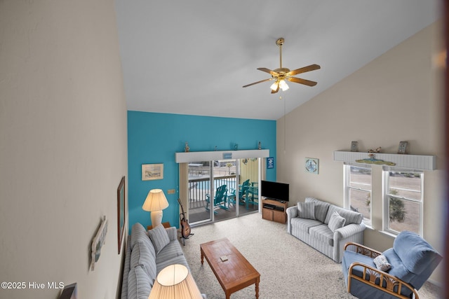 living area with ceiling fan, vaulted ceiling, and carpet flooring