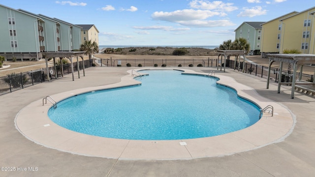 pool featuring a patio area, fence, and a pergola