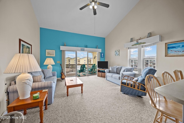 carpeted living room featuring ceiling fan and high vaulted ceiling