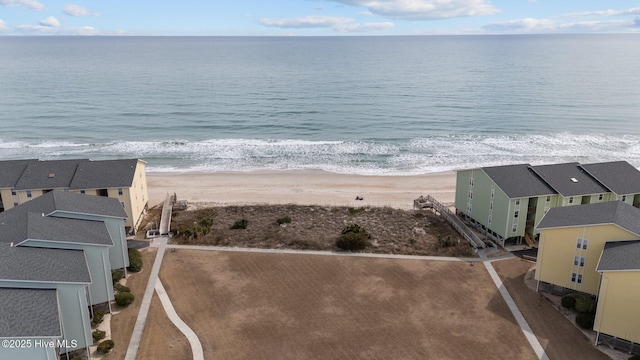 bird's eye view with a water view and a beach view