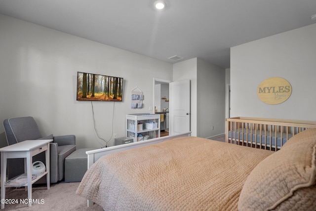 bedroom with visible vents and carpet flooring