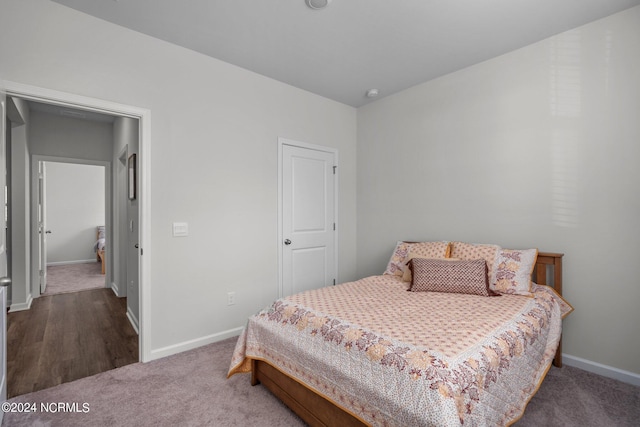 bedroom featuring baseboards and carpet flooring