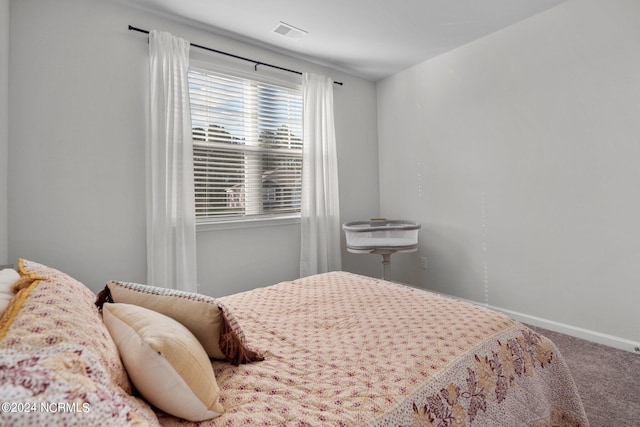 bedroom with carpet, visible vents, and baseboards