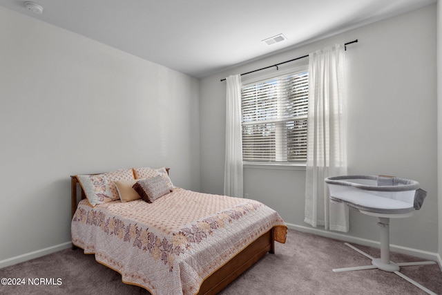 carpeted bedroom featuring visible vents and baseboards