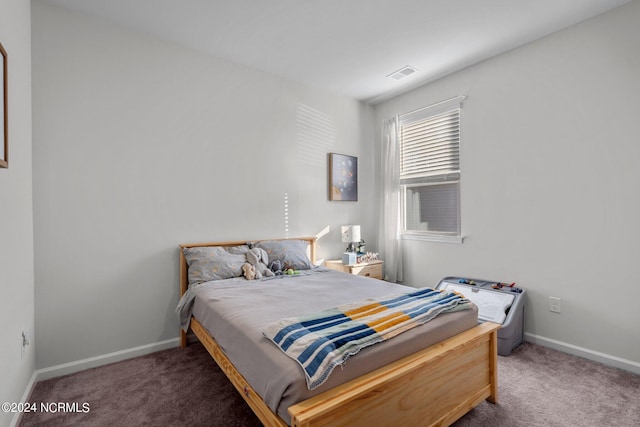 carpeted bedroom with baseboards and visible vents