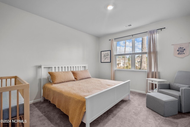 carpeted bedroom featuring visible vents and baseboards