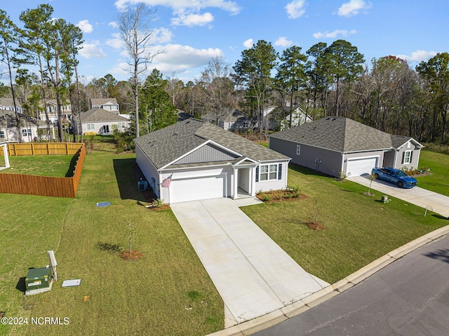 ranch-style house with a garage, concrete driveway, a front lawn, and a shingled roof