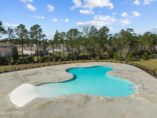 pool featuring a patio and fence